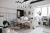 Bohemian-style attic living room with curtains hung from the sloping ceiling