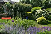 House garden with waddling pool, blue shrub bed