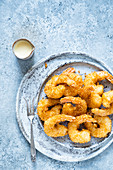 Coconut shrimps served with yogurt with turmeric