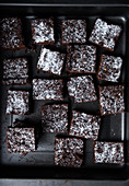 Vegan sweet potato brownies with icing sugar, sliced