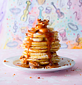 Pancakes with bananas, pecan nuts and caramel sauce