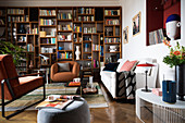 Living room in eclectic style with large bookcase along one wall