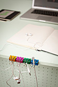 Colourful binder clips repurposed as cable organiser