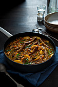 Sausage casserole cooked in cider with lentils apples and tarragon