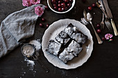 Chocolate cake with cherries and icing sugar