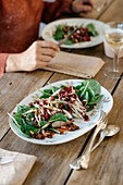 Spinatsalat mit karamellisierten Schalotten, Portwein-Rosinen und gerösteten Pinienkernen