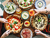 Three Assorted Pizzas;Pepperoni and Olive, Prosciutto Salad, Mozzarella and Basil; From Above