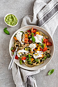 Tagliatelle with courgette, broad beans, tomatoes and pesto