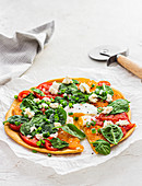 Socca pizza with spinach, tomatoes and egg