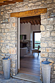 View through open door into Tuscan country house with stone walls