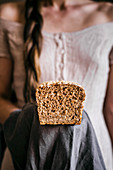 Woman Holding Honey Oat Bread