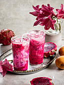 Mango Dragon Fruit Smoothie With Coconut Milk on the table