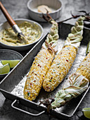 Mexican street corn on the cob. Ingredients off to the side