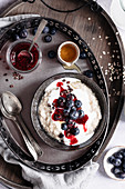 Berry oatmeal with yogurt on a tray