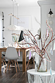 Branches of Japanese fantail willow decorated with handmade feather decorations