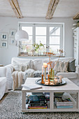 Autumn arrangement on coffee table in bright, shabby-chic living room