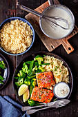 Baked salmon with cocuscous, veggies and lemon sauce