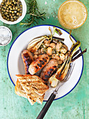 Grilled salsiccia with giant beans, capers and leek