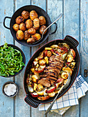 Roasted pork with oven potatoes, parsnips and apples