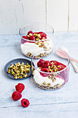 Cheesecake dessert with raspberries and roasted nut flakes