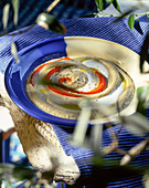 Hummus on a blue and white dish on an outdoor table