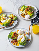 Breakfast salad with poached eggs and bacon croutons