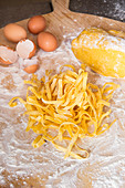 Homemade egg pasta on a floured surface