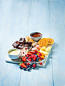 Dessert dipping platter with chocolat bark, dips and berry brownies