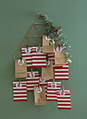Advent calendar made from red-and-white striped and brown paper bags