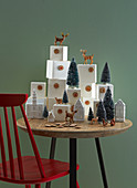 Advent calendar made from numbered boxes arranged with house-shaped ornaments