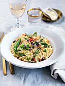 Vegeterian risotto with asparagus, soyabeans, herbs, sundried tomatoes and parmesan