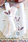 Napkin rings with floral bunny ears on set table