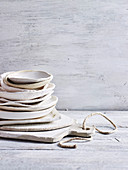 Stacked handmade ceramic plates on wooden cutting board