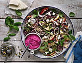 Salad with quinoa, apples, dill, basil, pumpkin seeds, beetroot hummus and feta