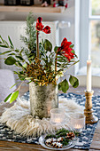 Wintry bouquet with branches and amaryllis on table