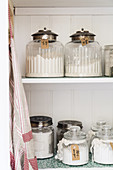 Vintage-style storage jars on kitchen shelves