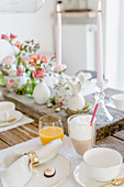 An Easter table decorated with candles, flowers and eggs