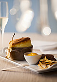 Pear soufflé with apricot sauce and pear chips