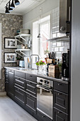 Black cabinets in kitchen in Scandinavian country-house style