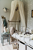 Antique bed with canopy in child's bedroom