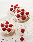 Pavlovas with raspberries and sugar hearts for Valentine's Day