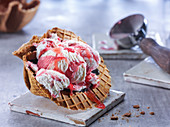 Strawberry yogurt ice cream in a waffle bowl