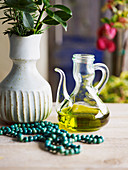 Olivenöl in Karaffe, Halskette und Krug mit Kräutern (Griechenland)