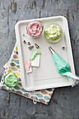 Coloured creams and a piping bag for cake decorations