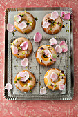 Pistachio and rose cakes with lemon glaze and candied rose petals