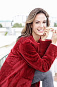 A young woman wearing a red coat