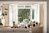 Beige living room with view onto sunny terrace