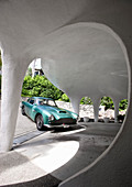 Green sports car in organically formed garage