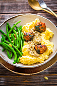 Polenta with chicken and spinach meatballs and green beans