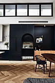 High, open living room with black fixtures and arched neckline